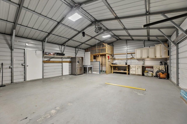 14138 State Highway 20, Niceville, FL 32578 - garage with stainless steel fridge with ice dispenser, metal wall, and a workshop area