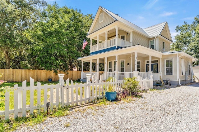 14138 State Highway 20, Niceville, FL 32578 - view of front facade featuring a porch, a balcony, a fenced front yard, and a metal roof