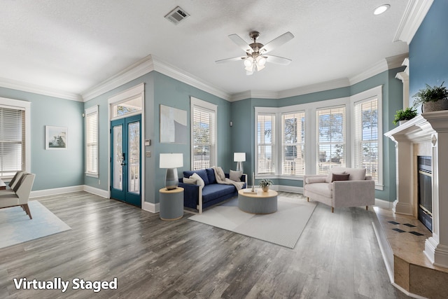 14138 State Highway 20, Niceville, FL 32578 - living room featuring a glass covered fireplace, wood finished floors, ceiling fan, ornamental molding, and a textured ceiling