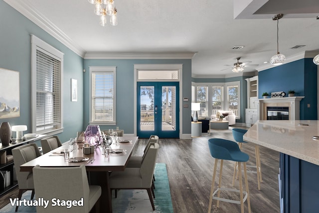 14138 State Highway 20, Niceville, FL 32578 - dining space featuring crown molding, dark wood-style floors, ceiling fan, plenty of natural light, and a glass covered fireplace