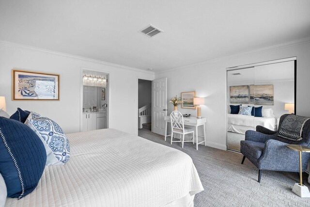 bedroom featuring carpet floors, ornamental molding, and connected bathroom