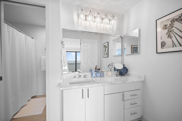 bathroom with hardwood / wood-style floors and vanity