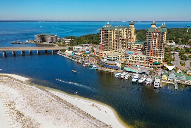 birds eye view of property with a water view and a beach view