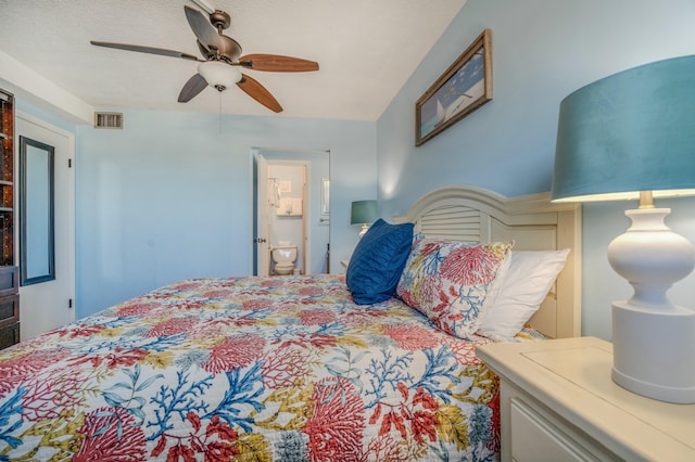 bedroom featuring ceiling fan, a textured ceiling, and connected bathroom