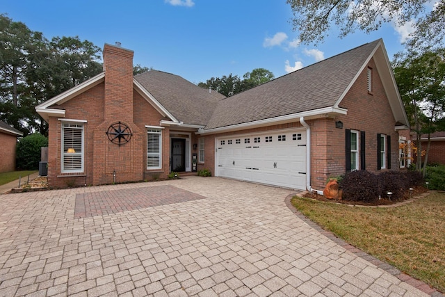 view of front property with cooling unit and a garage