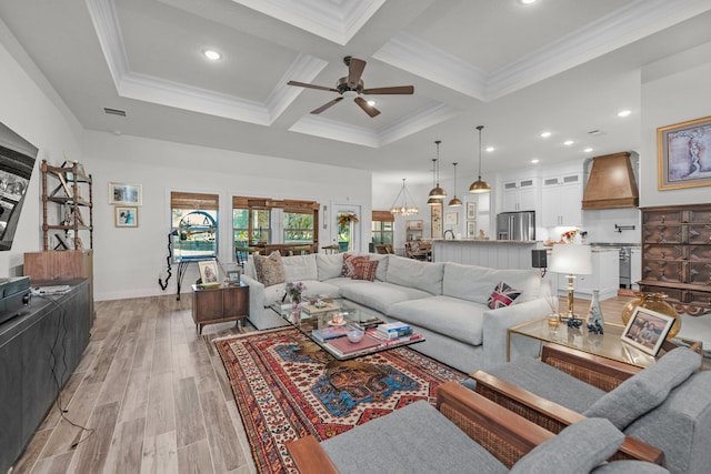 living room featuring coffered ceiling, beam ceiling, ceiling fan with notable chandelier, and crown molding