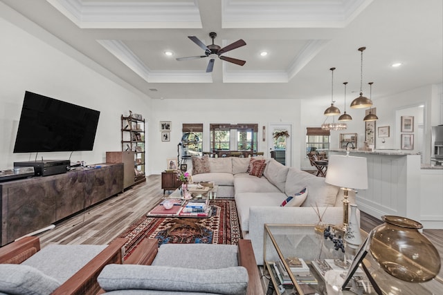 living room featuring coffered ceiling, light hardwood / wood-style flooring, ornamental molding, ceiling fan, and beam ceiling