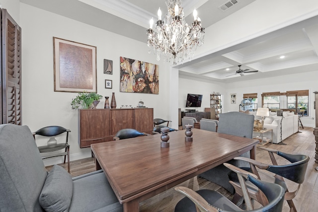 dining area with beamed ceiling, ornamental molding, coffered ceiling, ceiling fan, and light hardwood / wood-style floors