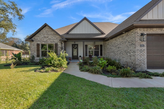 view of front of home with a porch, a garage, and a front yard