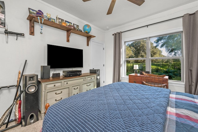 bedroom featuring ceiling fan, ornamental molding, carpet flooring, and multiple windows