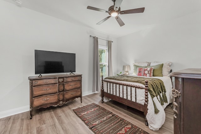 bedroom with light hardwood / wood-style flooring and ceiling fan