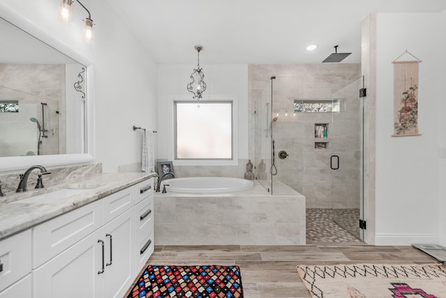 bathroom featuring shower with separate bathtub and vanity