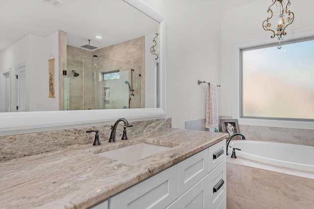 bathroom featuring vanity and independent shower and bath