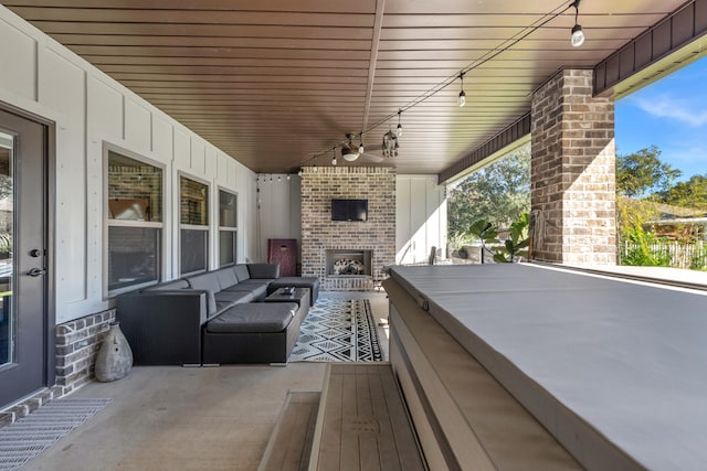 view of patio with an outdoor living space with a fireplace