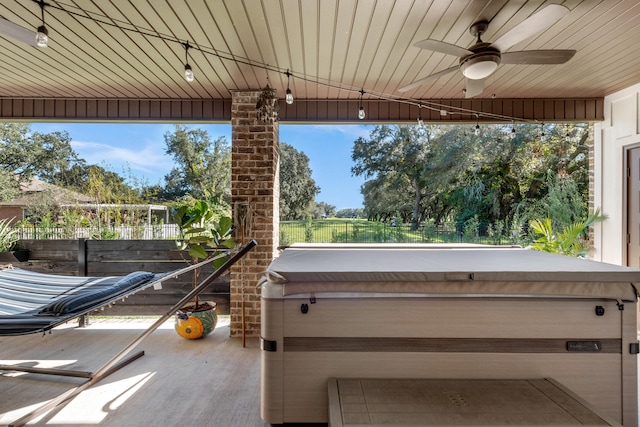 view of patio with a hot tub and ceiling fan