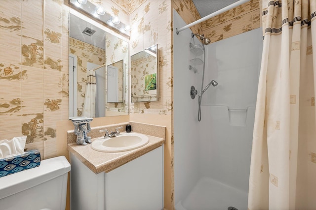 17751 Panama City Beach Pkwy Unit 13E, Panama City Beach, FL 32413 - bathroom with a shower stall, toilet, vanity, and wallpapered walls