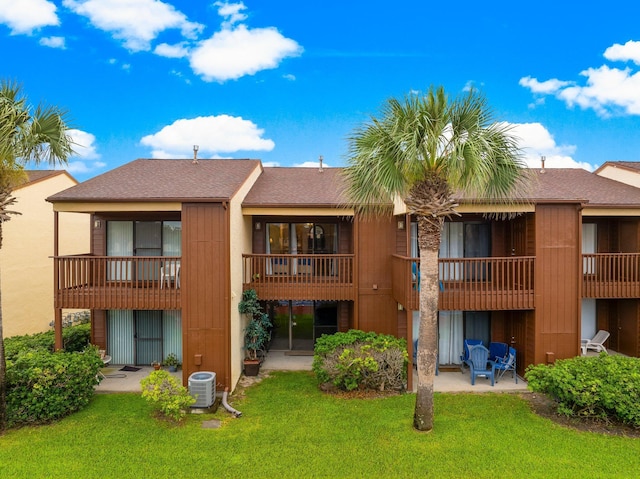 17751 Panama City Beach Pkwy Unit 13E, Panama City Beach, FL 32413 - rear view of property with a lawn, a shingled roof, a patio, and cooling unit