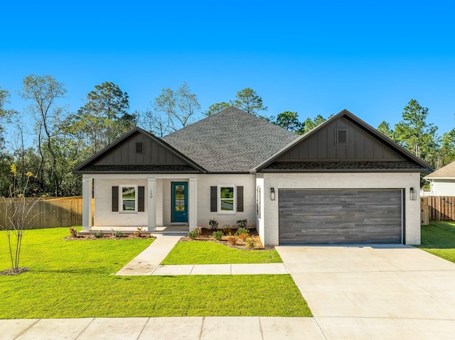 view of front of house with a front yard and a garage