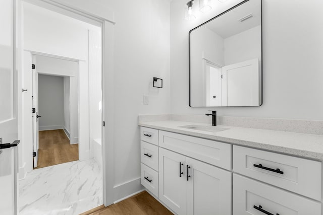 bathroom with hardwood / wood-style floors and vanity