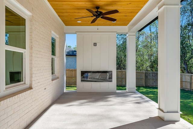 view of patio with ceiling fan and a water view