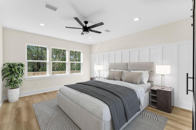 bedroom with light hardwood / wood-style flooring and ceiling fan