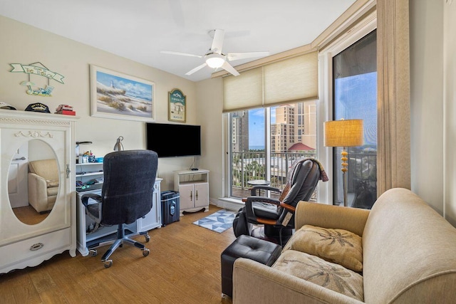 home office with hardwood / wood-style flooring and ceiling fan