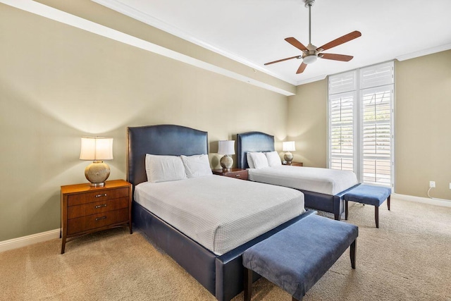 carpeted bedroom with ceiling fan and ornamental molding