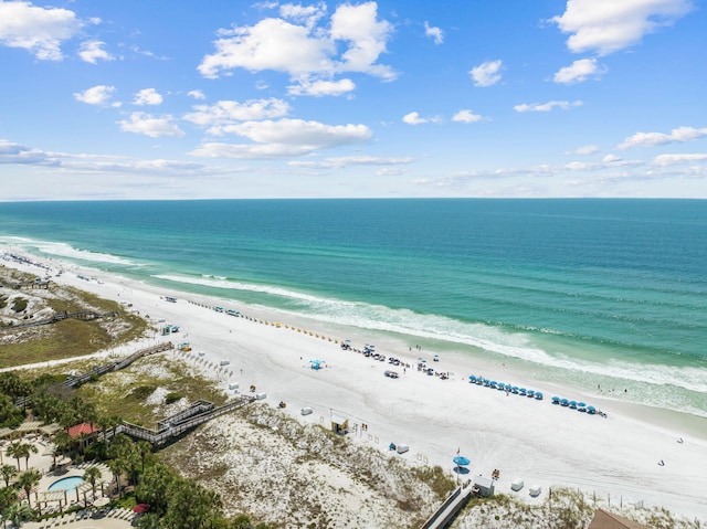 bird's eye view featuring a water view and a beach view