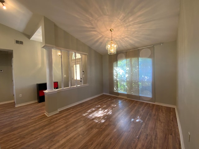 unfurnished dining area with dark hardwood / wood-style flooring, a chandelier, and vaulted ceiling