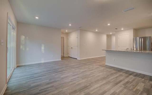 unfurnished living room with light hardwood / wood-style floors