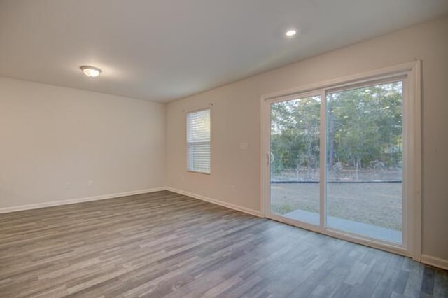 spare room with hardwood / wood-style flooring