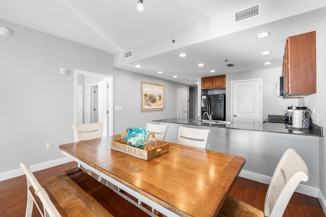 dining room with dark wood-type flooring and sink