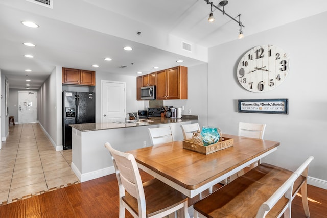 dining space with light hardwood / wood-style floors and sink