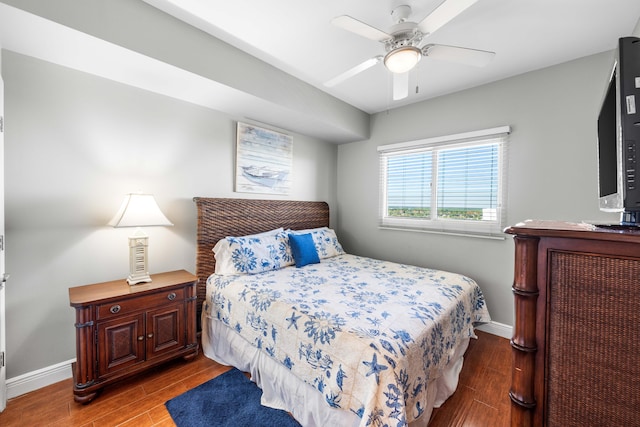 bedroom with dark hardwood / wood-style floors and ceiling fan