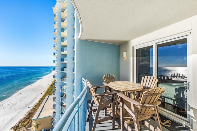 balcony featuring a water view and a beach view