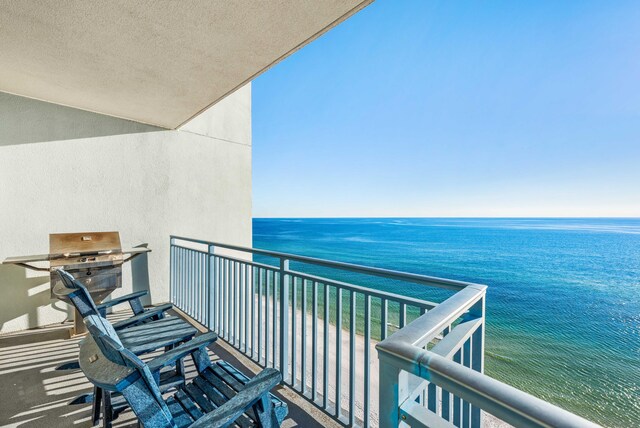 balcony featuring a grill and a water view