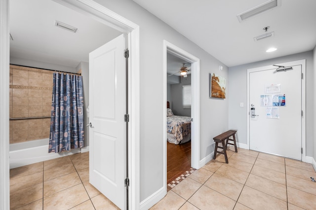 tiled entryway featuring ceiling fan