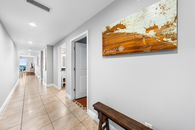 hall with light tile patterned floors