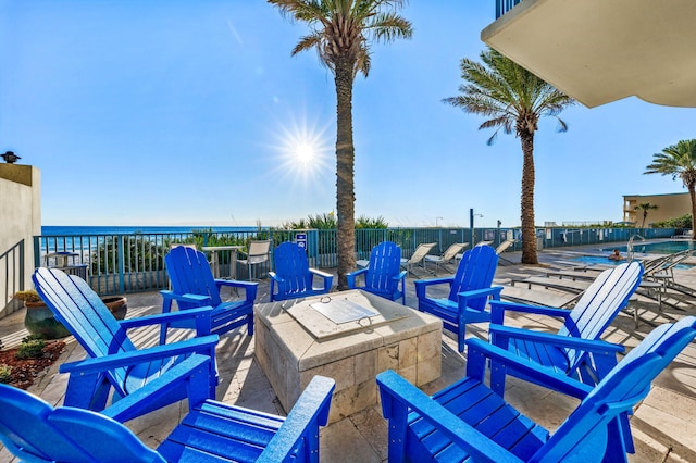 view of patio with a water view and an outdoor fire pit