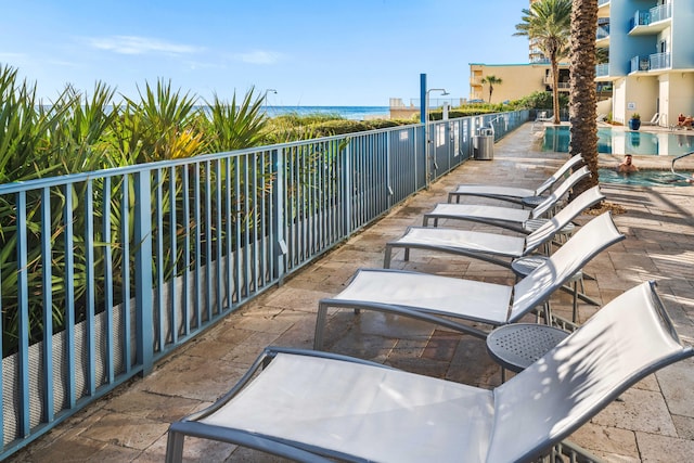 view of patio / terrace with a water view and a balcony