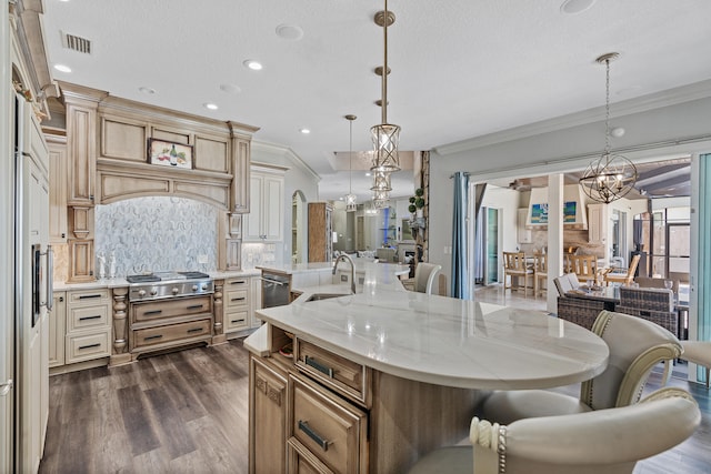 kitchen with pendant lighting, decorative backsplash, a spacious island, and sink