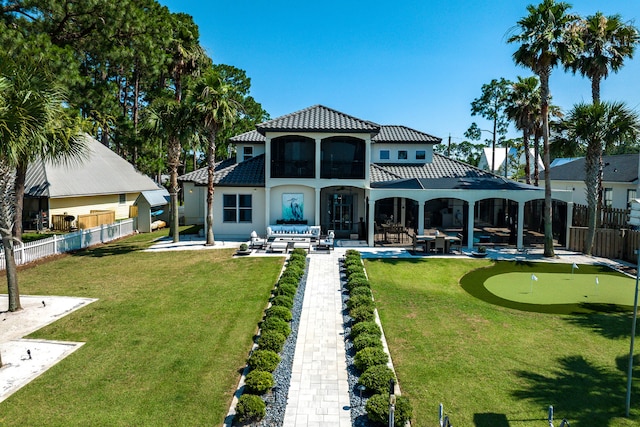 back of property with outdoor lounge area and a patio