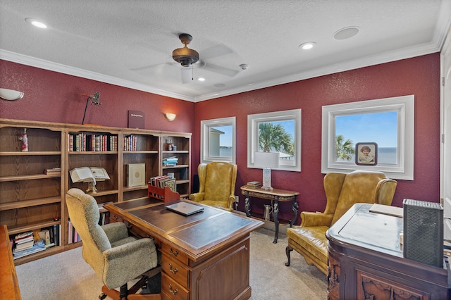 carpeted office with crown molding, ceiling fan, and a textured ceiling