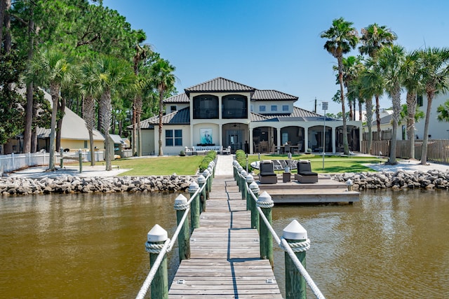 dock area featuring a water view and a lawn