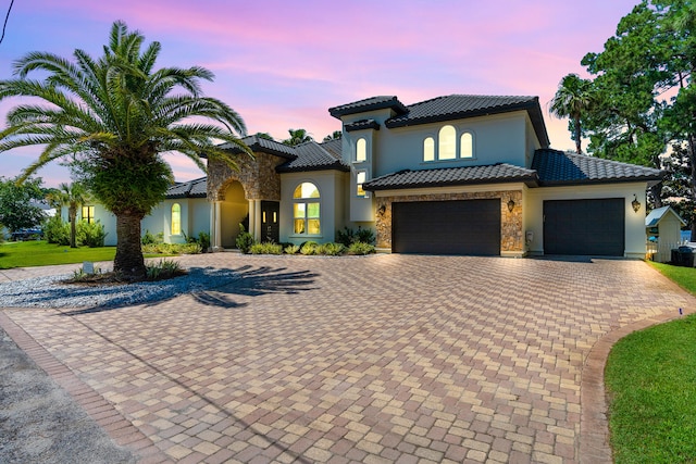 mediterranean / spanish house featuring a garage