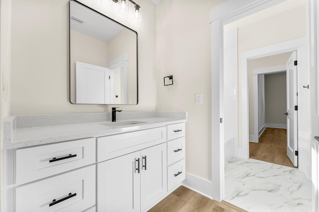 bathroom with vanity and hardwood / wood-style flooring