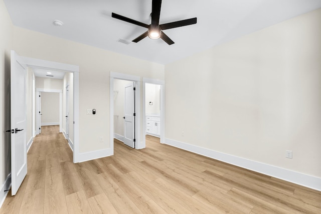 unfurnished bedroom featuring ceiling fan, ensuite bathroom, and light hardwood / wood-style floors