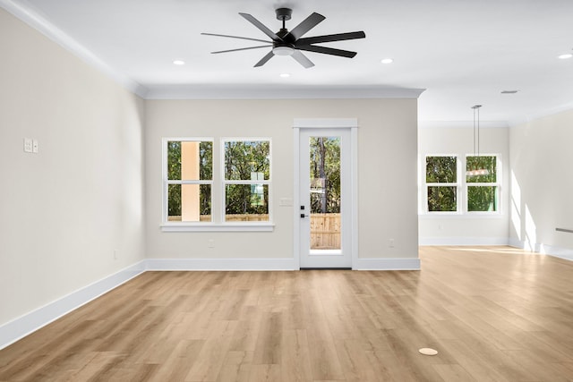 unfurnished living room with ceiling fan, ornamental molding, and light hardwood / wood-style flooring