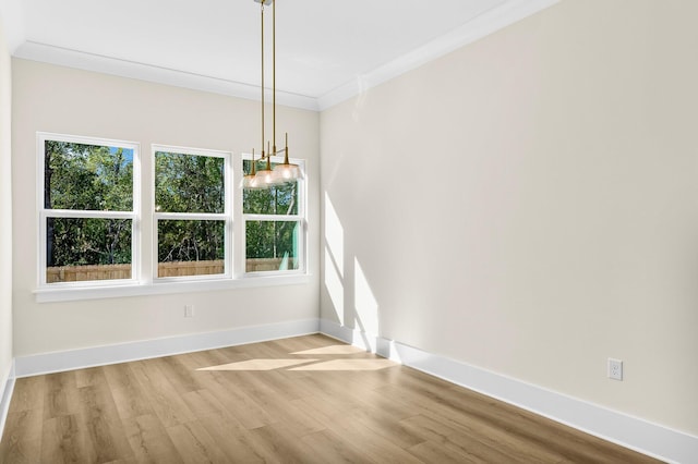 unfurnished dining area with light hardwood / wood-style floors and ornamental molding