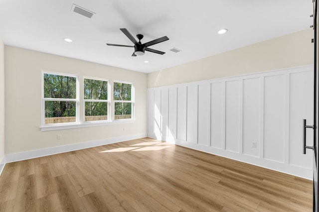 unfurnished room featuring ceiling fan and light wood-type flooring